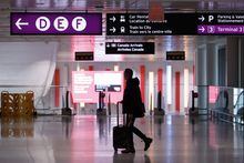 A traveller makes their way through Pearson International Airport in Toronto Monday, Nov. 14, 2022. Airlines are warning that travel in and out of Central Canada may be affected by a winter storm sweeping in from the west.THE CANADIAN PRESS/Cole Burston