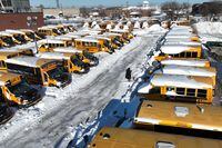 School buses lie idle and covered in snow after the Toronto District School Board (TDSB) announced a second day of closures due to heavy snowfall, at Stock Transportation in Scarborough, Ontario, Canada, January 18, 2022. Picture taken with a drone. REUTERS/Chris Helgren