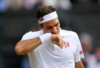 Tennis - Wimbledon - All England Lawn Tennis and Croquet Club, London, Britain - July 7, 2021  Switzerland's Roger Federer wipes his face during his quarter final match against Poland's Hubert Hurkacz REUTERS/Toby Melville