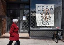 A hand painted sign about the Canada Emergency Business Account, is seen in front window of Frances Watson, a store on Queen St. West, on April 15 2020. Some businesses were happy to hear about the CEBA, but now find some of the requirements to hard to meet.