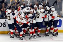 The Florida Panthers celebrate after defeating the Boston Bruins on a goal by Carter Verhaeghe in overtime during Game 7 of an NHL hockey Stanley Cup first-round playoff series, Sunday, April 30, 2023, in Boston. (AP Photo/Michael Dwyer)