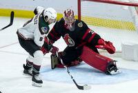 Arizona Coyotes centre Nick Schmaltz (8) controls the puck in front of Ottawa Senators goalie Filip Gustavsson before scoring the game winning goal in third period NHL action, Monday, March 14, 2022 in Ottawa.  The Arizona Coyotes defeated the Ottawa Senators 5-3. THE CANADIAN PRESS/Adrian Wyld