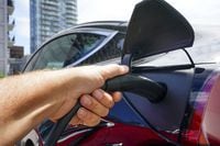 An electric vehicle is charged in Ottawa on Wednesday, July 13, 2022. BC Hydro wants to raise rates at public electric vehicle charging stations by 15 per cent from Sept. 1, which the company says would allow it to recover the costs of providing them over 10 years. THE CANADIAN PRESS/Sean Kilpatrick