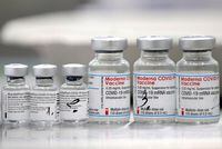 FILE PHOTO: Vials of coronavirus disease (COVID-19) vaccines of Pfizer-BioNTech and Moderna are seen during a trial run of a mass vaccination center located inside of a gym in the town of Ricany near Prague, Czech Republic, February 25, 2021.    REUTERS/David W Cerny/File Photo