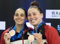 Canada’s Pamela Ware, left, and Mia Vallee pose with their bronze medals after finishing third in the women’s three-metre synchronized event at the World Aquatics Diving World Cup 2023 in Montreal on Friday, May 5, 2023. THE CANADIAN PRESS/Christinne Muschi