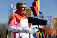 Olympics - Beijing 2022 Winter Olympics - Torch Relay - Beijing Olympic Park, Beijing, China - February 4, 2022. International Olympic Committee President Thomas Bach takes part in the relay of the Olympic flame. Pool via REUTERS/Wang Zhao