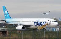 An Air Transat plane is seen as an Air Canada plane lands at Pierre Elliott Trudeau International Airport in Montreal on Thursday, May 16, 2019. THE CANADIAN PRESS/Ryan Remiorz
