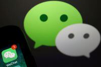 FILE PHOTO: The messenger app WeChat is seen next to its logo in this illustration picture taken August 7, 2020. REUTERS/Florence Lo/Illustration/File Photo