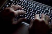A woman uses a keyboard in North Vancouver, B.C., Wednesday, Dec. 19, 2012. Prince Edward Island says a cyberattack has crashed its provincial government website.THE CANADIAN PRESS/Jonathan Hayward