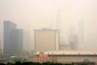 The Marriott Marquis, left, and the Hyatt Regency McCormick Place, center, stand above The McCormick Place Convention Center in a veil of haze from Canadian wildfires obscuring the majestic Chicago skyline, as seen from the city's Bronzeville neighborhood Tuesday, June 27, 2023, in Chicago. (AP Photo/Charles Rex Arbogast)