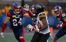 Hamilton Tiger-Cats running back Tayon Fleet-Davis (34) runs against Montreal Alouettes defensive back Marc-Antoine Dequoy (24) during first half CFL pre-season football action in Montreal on Friday, June 2, 2023.  THE CANADIAN PRESS/Christinne Muschi