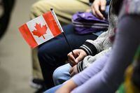 A young new Canadian holds a flag as she takes part in a citizenship ceremony on Parliament Hill in Ottawa on April 17, 2019. Within the span of just a few minutes, an online tool from Statistics Canada offers an evocative snapshot of Canada's ever-shifting population through a series of demographic models.THE CANADIAN PRESS/Sean Kilpatrick