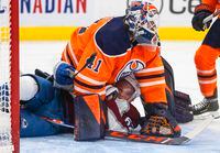 Colorado Avalanche's Artturi Lehkonen (62) is roughed up by Edmonton Oilers goalie Mike Smith (41) during third period NHL action in Edmonton, Friday, April 22, 2022. THE CANADIAN PRESS/Jason Franson 