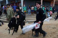 Federal Policemen carry seized material during a search operation for British journalist Dom Phillips and indigenous expert Bruno Pereira, who went missing while reporting in a remote and lawless part of the Amazon rainforest, near the border with Peru, in Atalaia do Norte, Amazonas state, Brazil June 14, 2022. REUTERS/Bruno Kelly