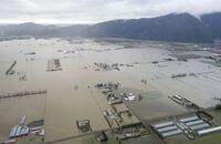 Floodwaters are seen from the air in Abbotsford, B.C., on Nov. 23, 2021. November's floods in British Columbia that swamped homes and farms, swept away roads and bridges and killed five people are now the mostly costly weather event in provincial history. THE CANADIAN PRESS/Jonathan Hayward