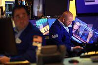 NEW YORK, NEW YORK - FEBRUARY 24: Traders work on the floor of the New York Stock Exchange (NYSE) on February 24, 2022 in New York City. U.S. stocks rallied before the closing bell after a sharp drop at its opening. The S&P 500 and Nasdaq Composite finished with gains after recouping their losses along with the Dow Jones which also rose. Stocks plunged this morning after news of Russia beginning its attack on Ukraine.  (Photo by Michael M. Santiago/Getty Images)