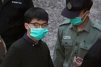 Hong Kong activist Joshua Wong is escorted by Correctional Services officers in Hong Kong, on Dec. 2, 2020.