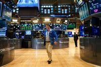Traders work on the floor at the New York Stock Exchange in New York, Tuesday, Oct. 4.