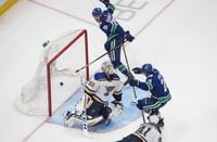 Vancouver Canucks' Antoine Roussel (26) and Adam Gaudette (88), celebrate a goal on St. Louis Blues goalie Jordan Binnington (50) during second period NHL Western Conference Stanley Cup playoff action in Edmonton on Friday, August 21, 2020.