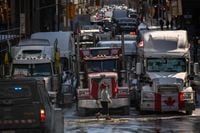 Vehicles block a road during a protest by truck drivers over pandemic health rules and the Trudeau government, outside the parliament of Canada in Ottawa on February 15, 2022. (Photo by Ed JONES / AFP) (Photo by ED JONES/AFP via Getty Images)
