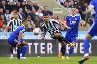 Newcastle's Bruno Guimaraes, center, battles for the ball with Leicester's Jamie Vardy, right, and Youri Tielemans during the English Premier League soccer match between Newcastle United and Leicester City at St. James' Park, Newcastle upon Tyne, England, Monday, May 22, 2023. (Owen Humphreys/PA via AP)