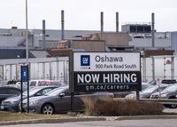 A sign announcing hiring is shown at the General Motors facility in Oshawa, Ontario on Monday April 4, 2022.&nbsp;Unifor members at a trio of major automakers have voted overwhelmingly for strike mandates, authorizing their bargaining committees to take labour action if collective agreements can't be reached. THE CANADIAN PRESS/Frank Gunn