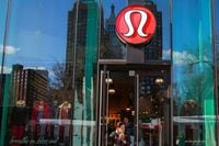 FILE PHOTO: A shopper walks out of the Lululemon Athletica store in New York, December 16, 2013.  REUTERS/Shannon Stapleton  (UNITED STATES - Tags: BUSINESS FASHION TEXTILE)/File Photo