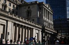 FILE PHOTO: People walk outside the Bank of England in the City of London financial district in London, Britain May 11, 2023. REUTERS/Henry Nicholls