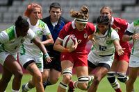 Canada's Karen Paquin, centre, is pursued by Brazil's, from left, Mariana Nicolau, Luiza Campos, and Thalita da Silva Costa, as she runs on her way to scoring a try, in their women's rugby sevens match at the 2020 Summer Olympics, Thursday, July 29, 2021 in Tokyo, Japan. Veteran flanker Paquin and Canada face the U.S. for the second time in a week Saturday at the Rugby World Cup in New Zealand. But this time it's win or go home as the North American rivals meet in the quarterfinal. THE CANADIAN PRESS/AP/Shuji Kajiyama
