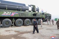 FILE PHOTO: North Korean leader Kim Jong Un walks next to what state media reports is the "Hwasong-17" intercontinental ballistic missile (ICBM) on its launch vehicle in this undated photo released on March 25, 2022 by North Korea's Korean Central News Agency (KCNA). KCNA via REUTERS