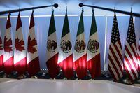 National flags representing Canada, Mexico, and the U.S. are lit by stage lights at the North American Free Trade Agreement, NAFTA, renegotiations, in Mexico City, Tuesday, Sept. 5, 2017. Senators on Capitol Hill have finally approved the latest version of North America's free trade pact. THE CANADIAN PRESS/AP/Marco Ugarte