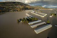 Rising flood waters are seen surrounding barns in Abbotsford, B.C., Tuesday, Nov. 16, 2021. A recovery package is expected to be announced today for British Columbia's agriculture industry after devastating floods last November. THE CANADIAN PRESS/Jonathan Hayward