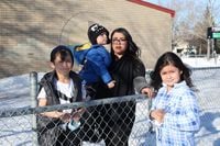 Maria Rodriguez and her children, Ana Barahona-Krenn, Paolo Barahona-Krenn and Julius Zimmer, outside École Constable Edward Finney School in Winnipeg on March 17, 2022. SHANNON VANRAES / THE GLOBE AND MAIL