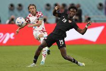 Croatia's Luka Modric, left, pass the ball past Canada's Ismael Kone during the World Cup group F soccer match between Croatia and Canada, at the Khalifa International Stadium in Doha, Qatar, Sunday, Nov. 27, 2022.&nbsp;Kone showed off his speed and power Tuesday in a head-turning showing in the Canadian midfield with Stephen Eustaquio and Jonathan Osorio as Canada defeated Honduras 4-1 in CONCACAF Nations League play.&nbsp;THE CANADIAN PRESS/AP, Darko Vojinovic