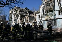 Ukrainian State Emergency Service firefighters inspect a damaged house after Russian shelling hit in Zaporizhzhia, Ukraine, Thursday, March 2, 2023. (AP Photo/Andriy Andriyenko)