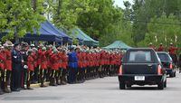 As RCMP salute, the hearses bearing three fallen officers leave the Moncton Coliseum after an RCMP Regimental Funeral service on June 10 2014. Five officers were allegedly shot by Justin Bourque and three of the five have died. Bourque was taken in a manhunt is now charged with first degree murder in the deaths of the three RCMP officers. (Fred Lum/The Globe and Mail)
