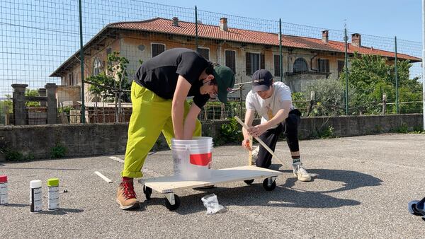 Ben Doyle (left) and Adam Chase, contestants in and co-creators of 'Jet Lag: The Game,' take part in a challenge to build a go-kart in Milan, Italy.