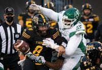 Hamilton Tiger Cats quarterback Jeremiah Masoli (8) is sacked by Saskatchewan Roughriders defensive back Rolan Milligan (32) and defensive lineman Charbel Dabire (98)during first half CFL game action in Hamilton, Ont. on Saturday, Nov. 20, 2021. THE CANADIAN PRESS/Peter Power