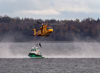 A Royal Canadian Air Force CH-149 Cormorant helicopter performs search and rescue training with M/V Halmar, in the Halifax harbour, on Oct. 27, 2020.