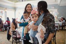 Shakina Rajendram, right, holds her daughter, Adiah while her sister-in-law, Sharon Nadarajah, left, holds Adiah’s twin brother, Adrial, at the twins’ first birthday celebration. Born at 22 weeks, Adiah and Adrial hold the Guinness World Record for world’s most premature twins