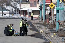 Police officers investigate the scene in Amqui, Que., Tuesday, March 14, 2023. Provincial police say a third person has died in connection with an incident in an eastern Quebec town one week ago when a pickup truck crashed into pedestrians, striking 11 people. THE CANADIAN PRESS/Jacques Boissinot
