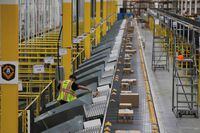 FILE PHOTO: Amazon packages are pushed onto ramps leading to delivery trucks by a robotic system as they travel on conveyor belts inside of an Amazon fulfillment center on Cyber Monday in Robbinsville, New Jersey, U.S., December 2, 2019.  REUTERS/Lucas Jackson/File Photo