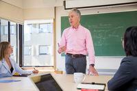 David Dunne, director of MBA Programs at the University of Victoria’s Gustavson School of Business, speaks to students in a classroom on campus.