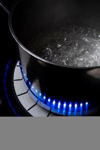 An induction cooktop with blue lights that mimic the flames of a gas stove, at the home of Robert Osborne in Brooklyn, March 8, 2022. It took Osborne a few weeks to get used to his induction stove, but now he loves its ability to maintain even temperatures at both low and high heat. (Karsten Moran/The New York Times)