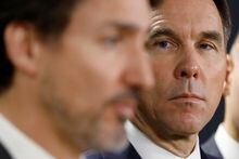 Canada's Minister of Finance Bill Morneau looks at Prime Minister Justin Trudeau during a press conference in Ottawa, Ontario, Canada March 11, 2020. REUTERS/Blair Gable