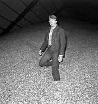 JIMMY CARTER AT THE PEANUT WAREHOUSE -- Jimmy Carter stands in a large mound of peanuts at the Carter Peanut Warehouse in Plains, Ga., Sept. 22, 1976. Jimmy Carter is a peanut farmer-turned-governor.   (AP Photo)