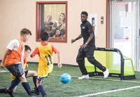 Canadian international Alphonso Davies plays soccer with kids as he hosts a soccer camp for kids in Edmonton, Alta., on Tuesday June 6, 2023. Davies plays in the Bundesliga for Bayern Munich. THE CANADIAN PRESS/Jason Franson