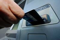 A person inserts a debit card into an ATM in Pittsburgh, Saturday, Jan. 5, 2013. Emergency funds can provide some peace of mind for those handling obstacles that pop up in life. THE CANADIAN PRESS/AP-Gene J. Puskar