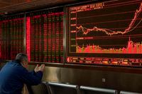 In this Jan. 16, 2020, file photo, an investor monitors stock prices at a brokerage in Beijing.