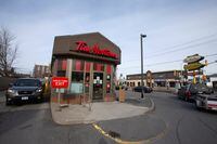 Cars pull up to a Tim Hortons coffee shop drive-thru after movement restrictions came into effect due to coronavirus disease (COVID-19) in the border town of Cornwall, Ontario, Canada March 25, 2020. Picture taken March 25, 2020.  REUTERS/Christinne Muschi